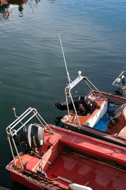 Two red boats docked in dark water