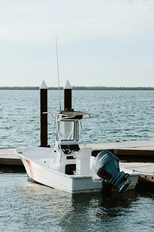 A white fishing boat docked on the water