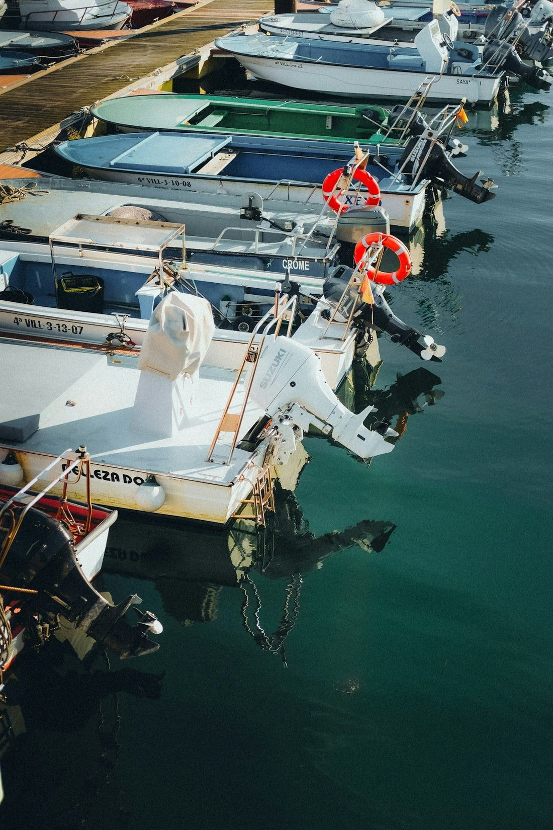 Several boats docked in a marina on a sunny day