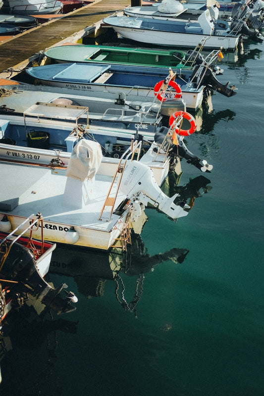 Several boats docked in a marina on a sunny day
