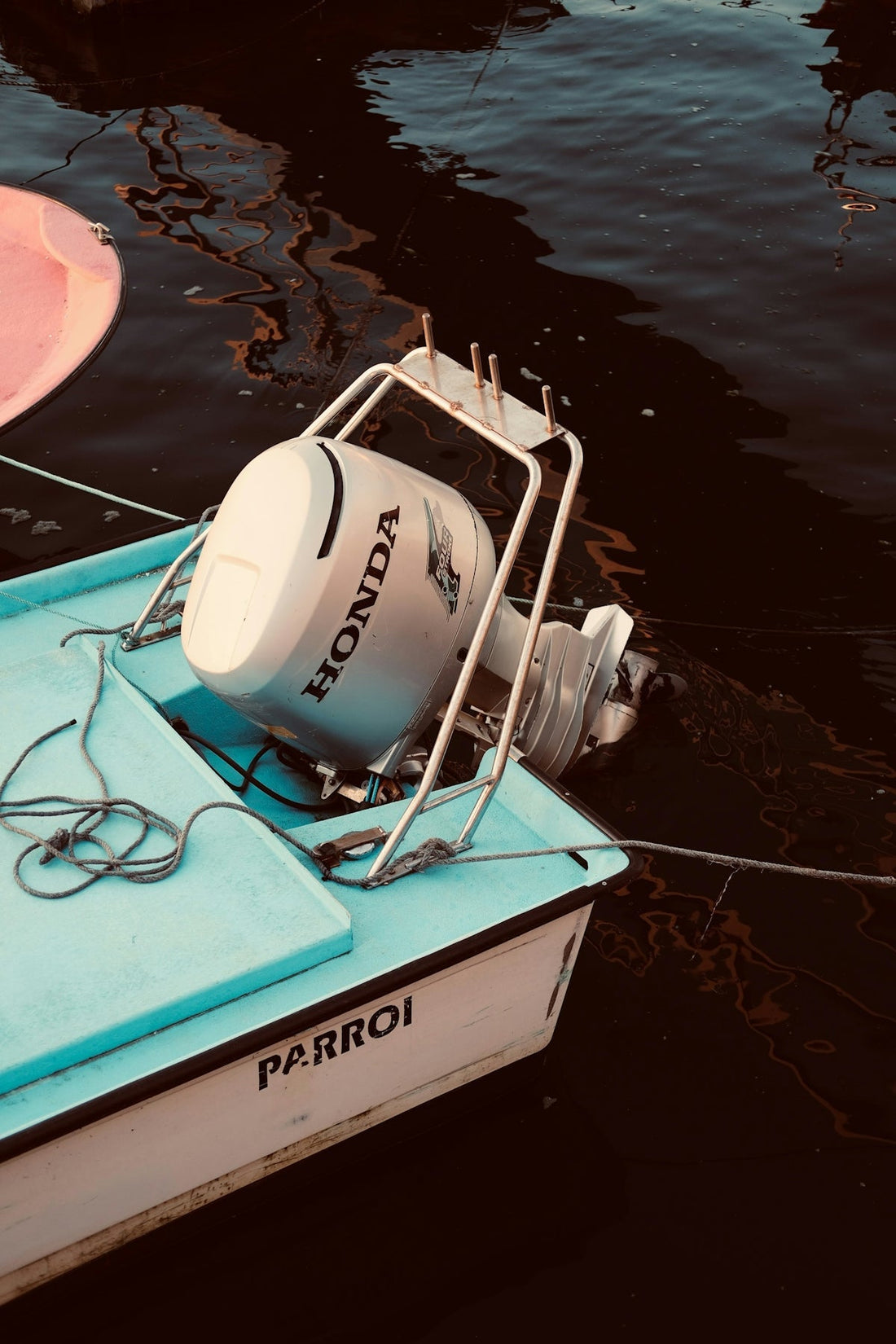 Small boat with honda outboard motor docked